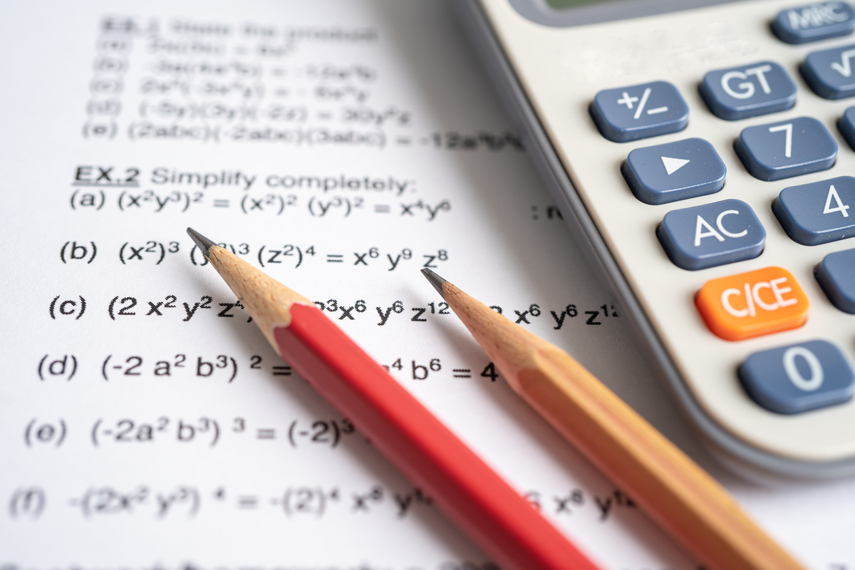 Pencil and Calculator on Mathematic Formula Exercise Test Paper